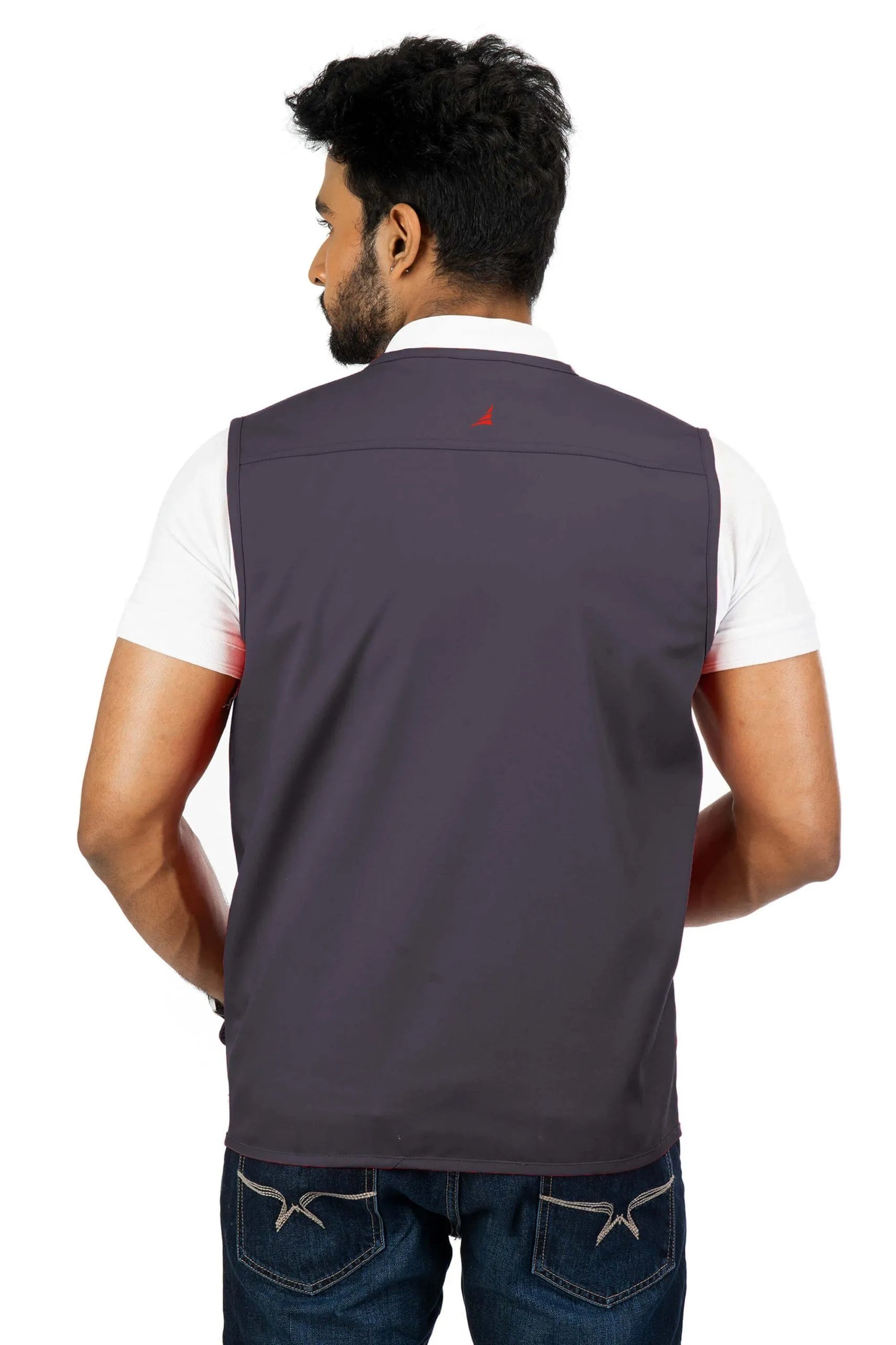 Man wearing dark gray Corbett Carbon multi-utility safari vest over white short-sleeve shirt, back view