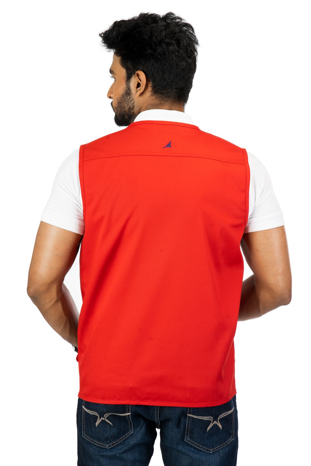 Man wearing a red multi-utility safari vest from the back, paired with a white shirt and blue jeans