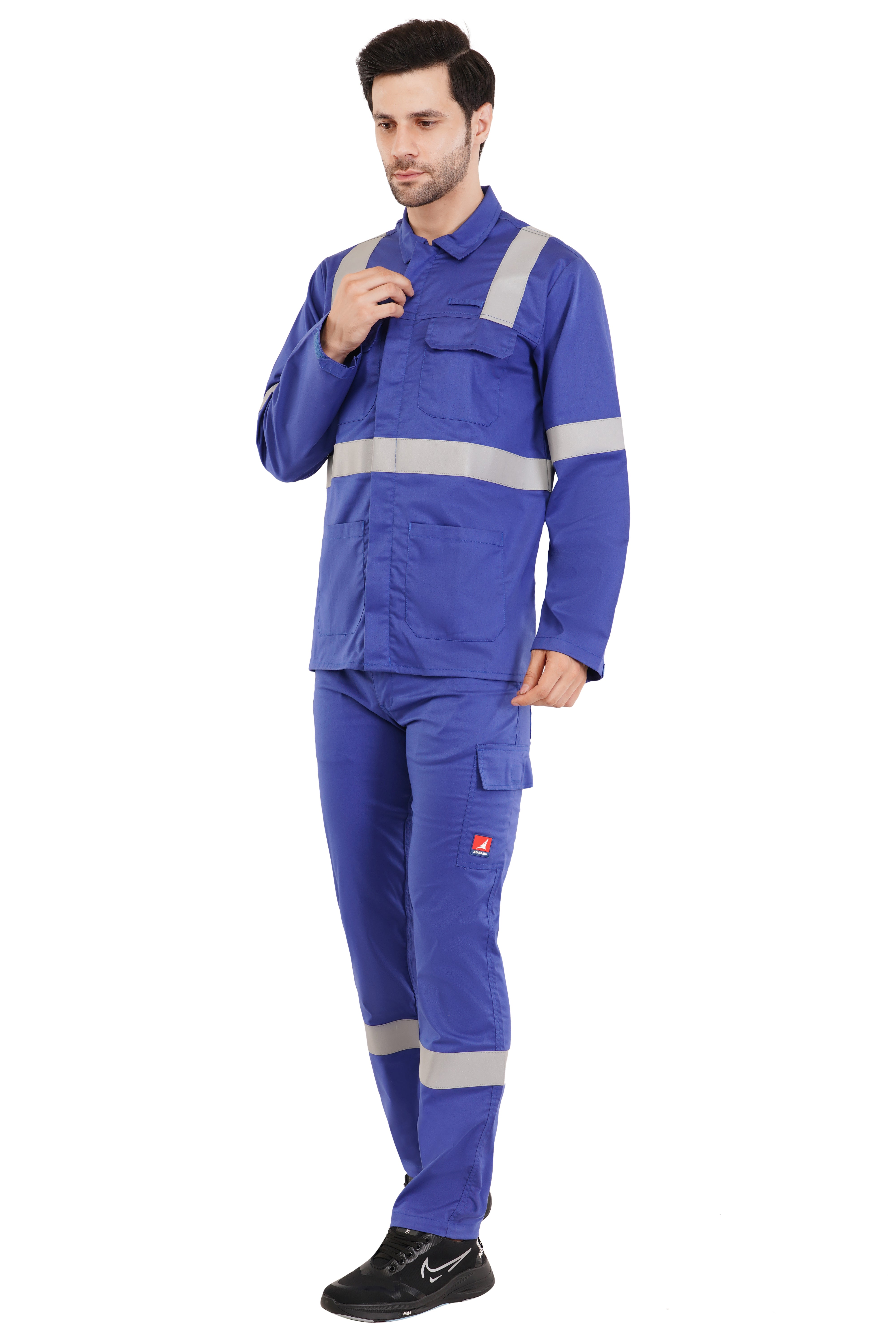 Man wearing blue industrial work jacket and trousers set with gray reflective stripes and multiple pockets, front view