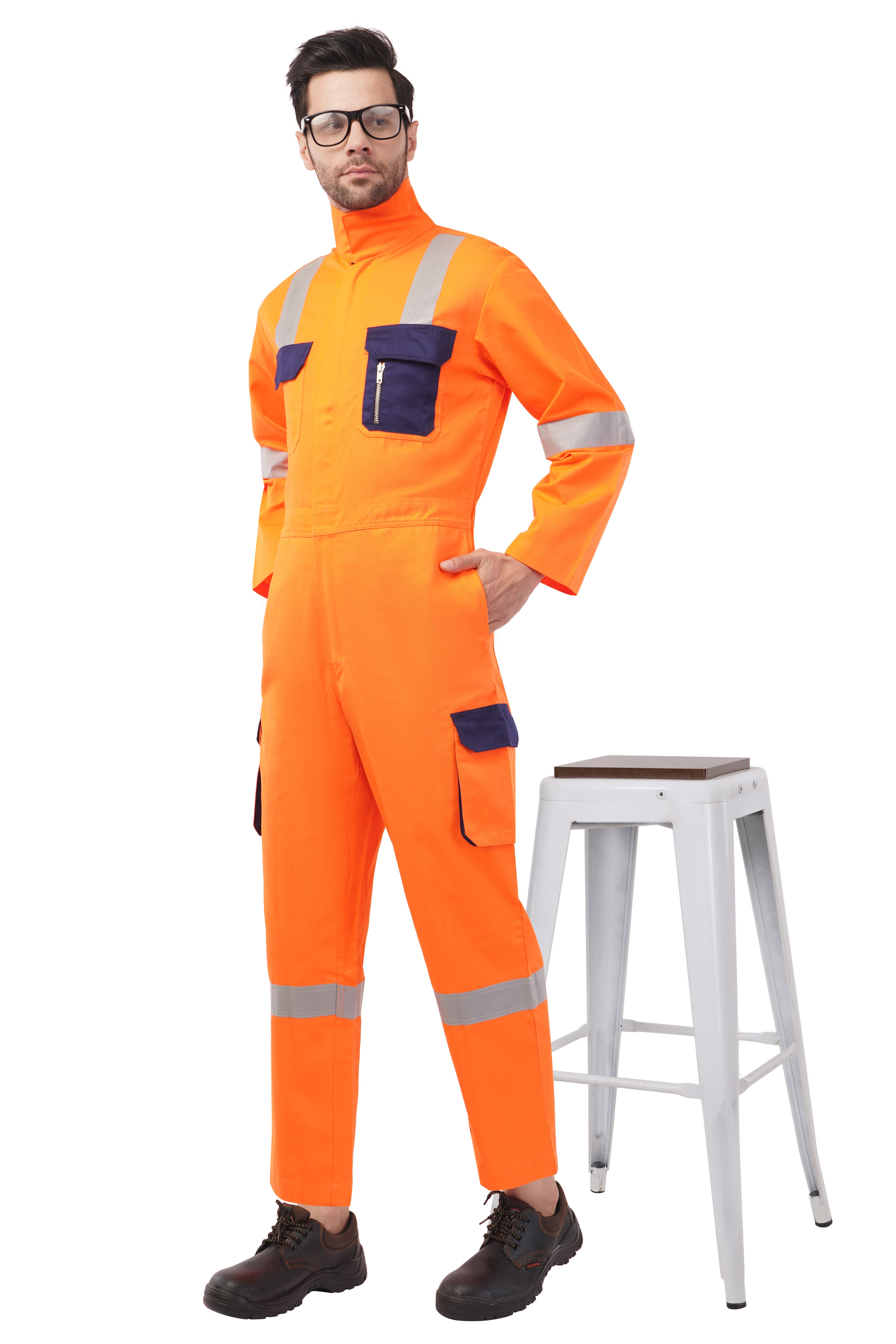 Atacama Drillking Industrial Coverall, reflective PC blend twill, bright orange with navy pockets, worn by a model.