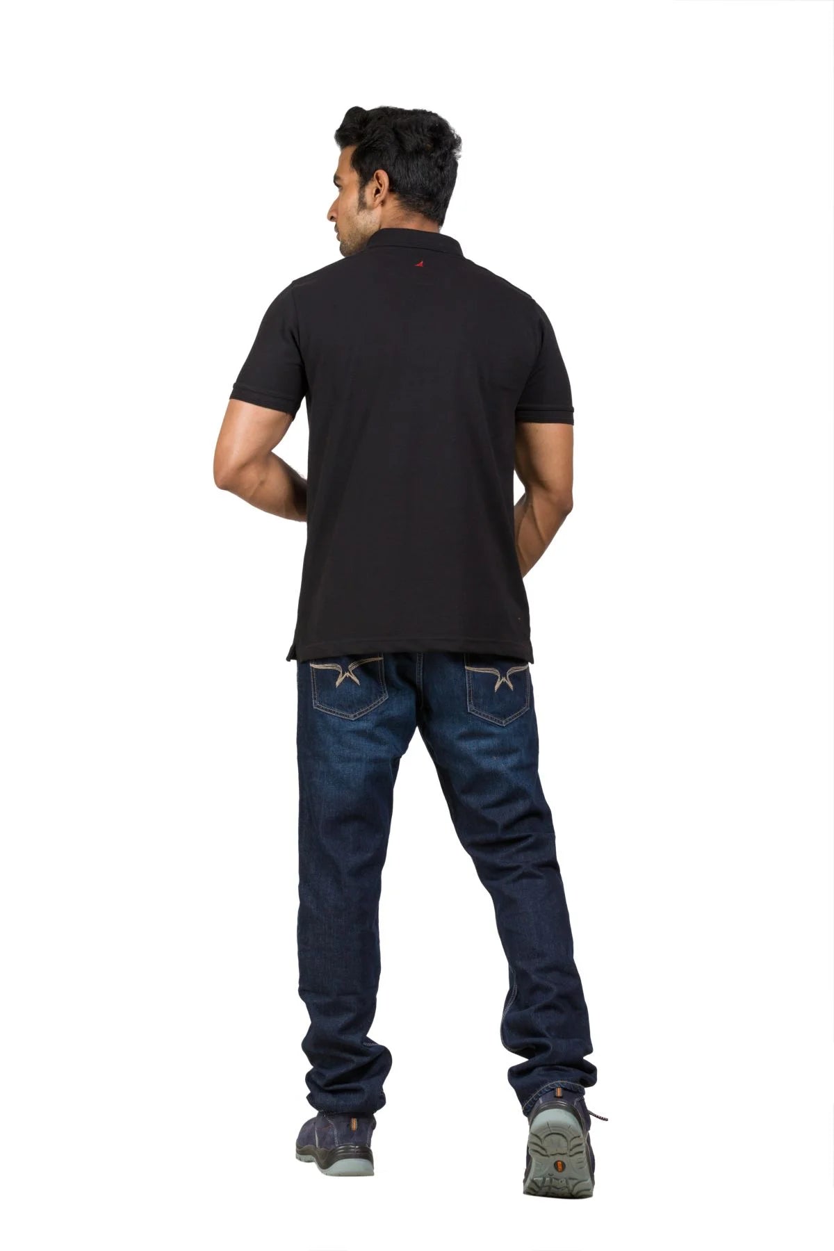 Alamo Men's Classic Fit Cotton Rich Polo T-shirt in black, worn with blue jeans, viewed from the back.
