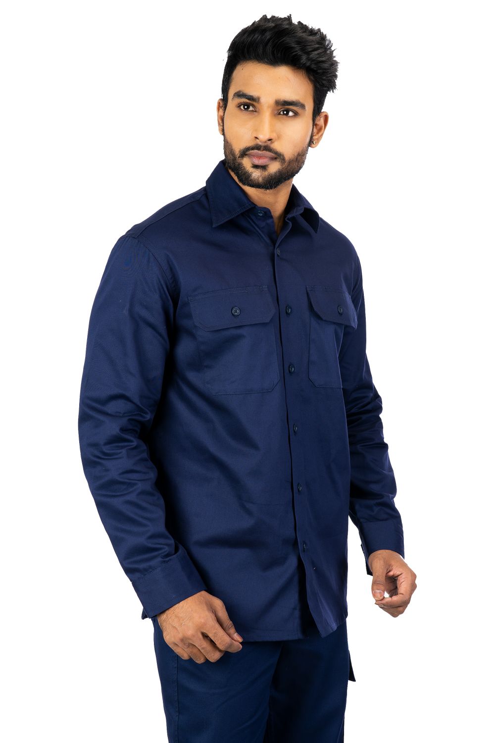 Man wearing navy blue Secura industrial work shirt with buttoned chest pockets and long sleeves, front view angled left