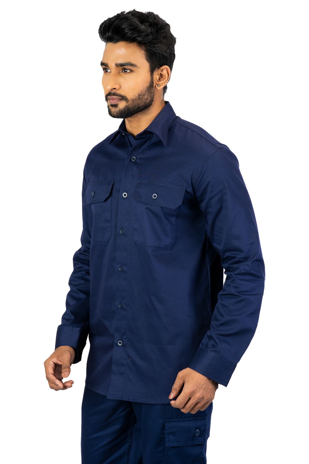 Men's navy blue industrial work shirt with buttoned chest pockets, long sleeves, worn by model front side view