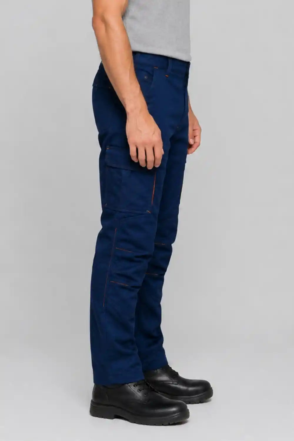 Person wearing blue cargo pants on a gray background