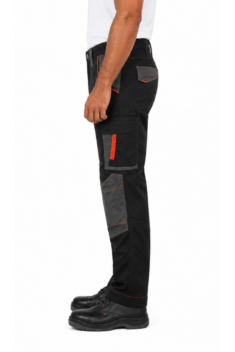 Black and dark grey workwear trousers worn by model, side view, with orange zipper and pocket details, paired with black