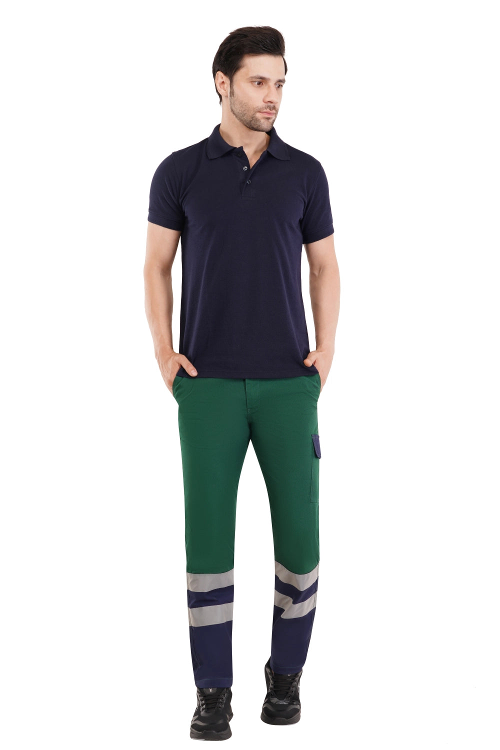 Man wearing a green work pants with reflective stripes from Atacama