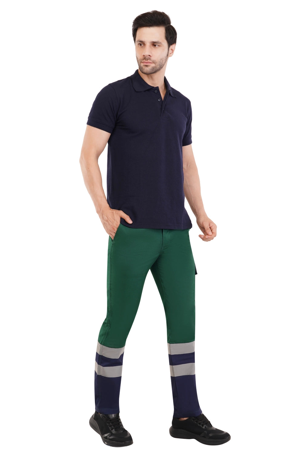 Man wearing a navy polo shirt and green work pants with reflective stripes on a white background