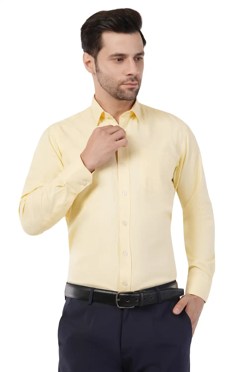 Man wearing a light yellow dress shirt from www.atacamapro.com and dark pants on a white background