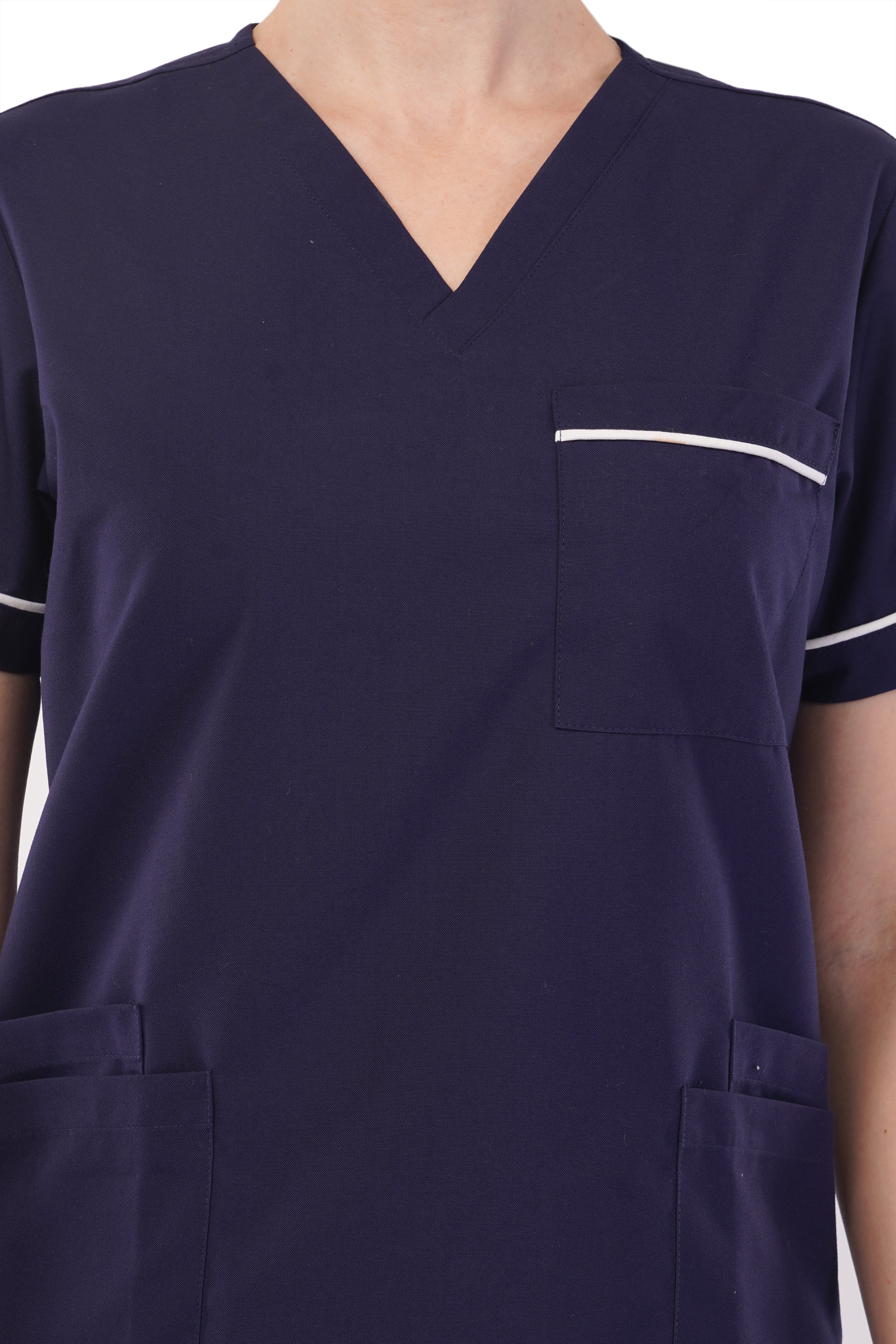 Navy stretchy scrub set by Atacama, featuring a v-neck, pocket, and white trim. Made of polyester/spandex.