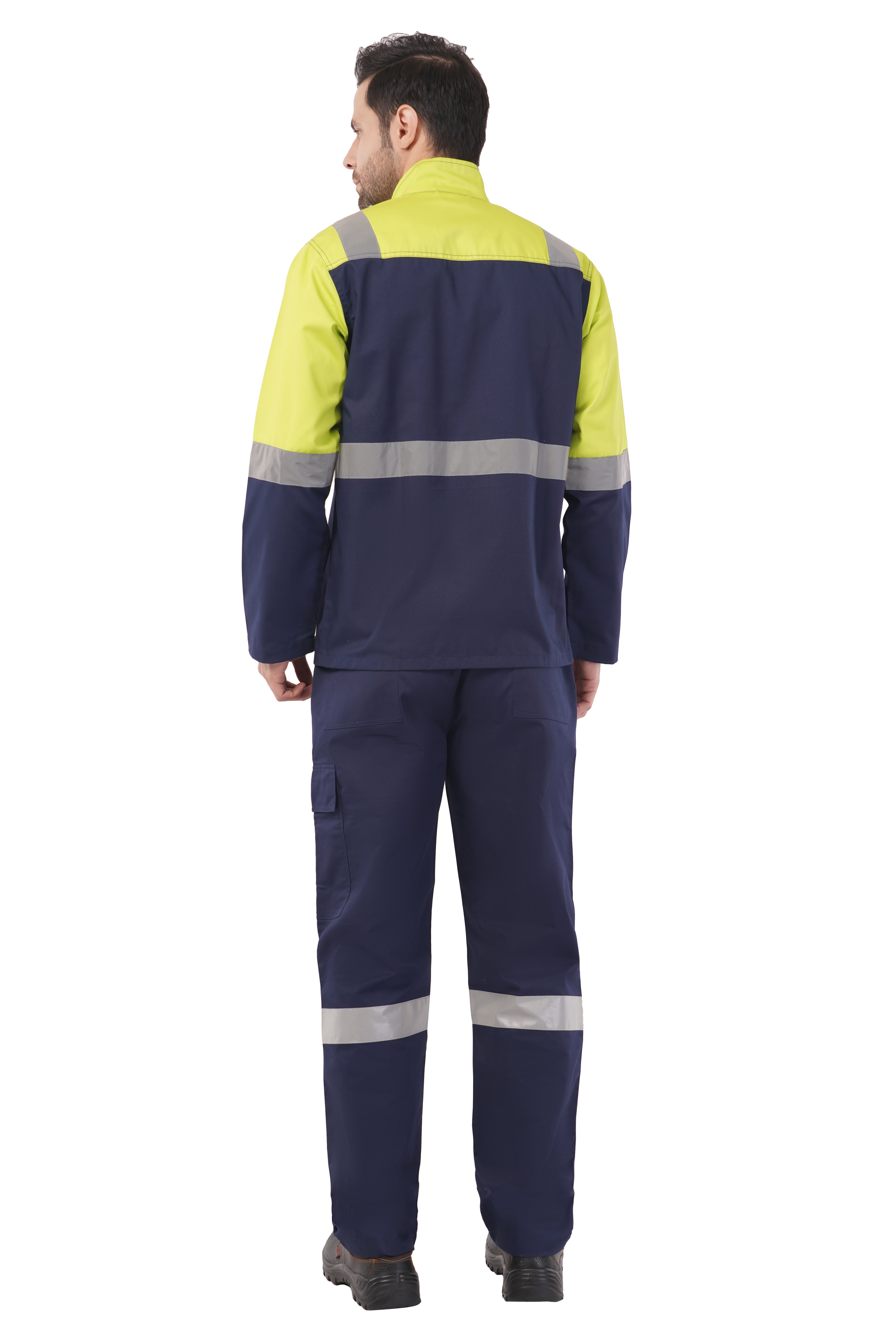 Man wearing navy blue and high-visibility yellow safety jacket and trousers with reflective silver bands, back view