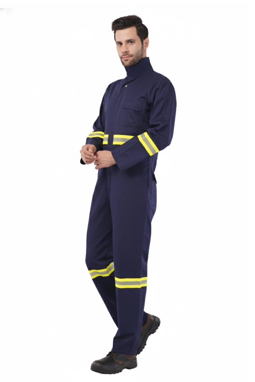 Person wearing a navy blue and yellow Atacama coverall with reflective stripes on a white background